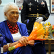 Romay Davis, 102, holds flowers after a ceremony honoring her service in World War II during a ceremony in Montgomery, Ala., on Tuesday, July 26, 2022.